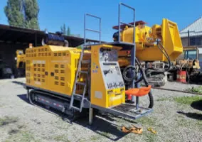 Crawler-mounted drill rig at a field camp