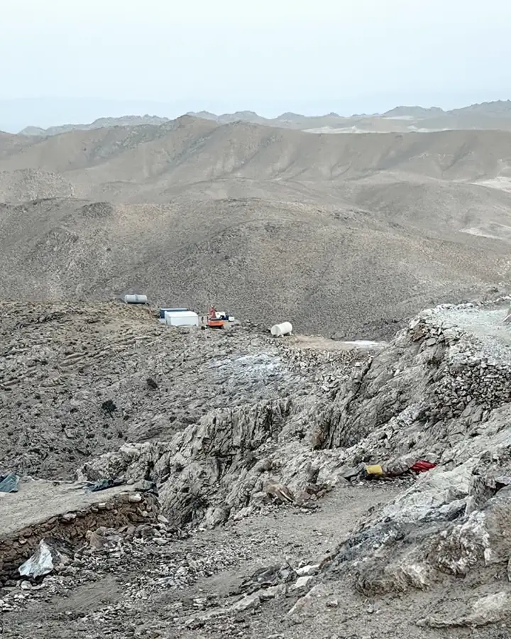 Exploration camp on a mountain ridge with access road and trenches